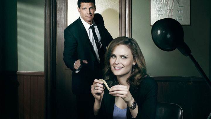 Bones – Emily Deschanel Smiling Sitting Pose in Office